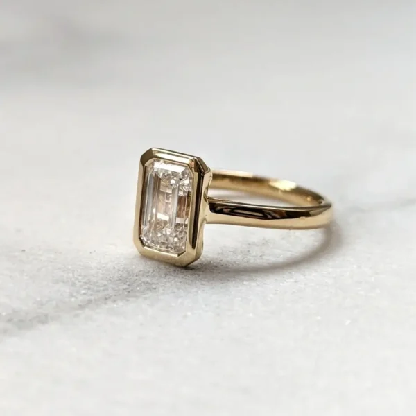 bezel set emerald cut diamond engagement ring